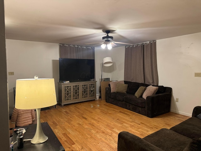 living room featuring ceiling fan and light hardwood / wood-style flooring