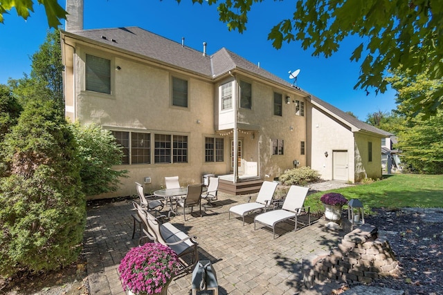 rear view of house with a patio and a yard