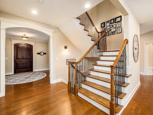 foyer with ornamental molding and wood-type flooring