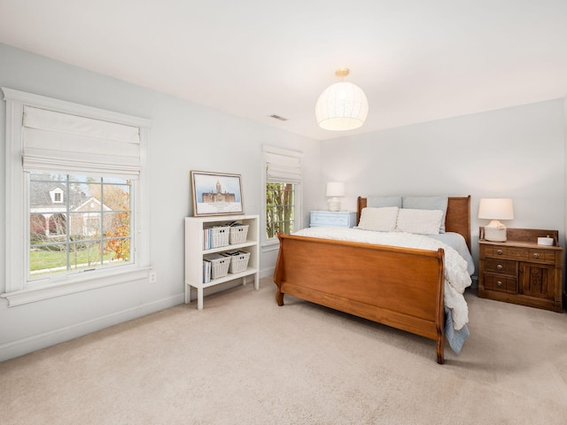 carpeted bedroom with multiple windows