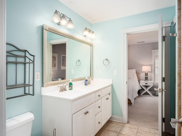 bathroom with vanity, tile patterned floors, and toilet