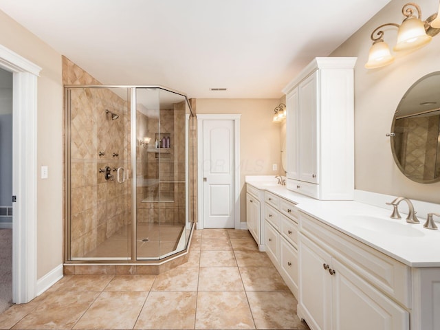 bathroom featuring vanity, a shower with door, and tile patterned flooring