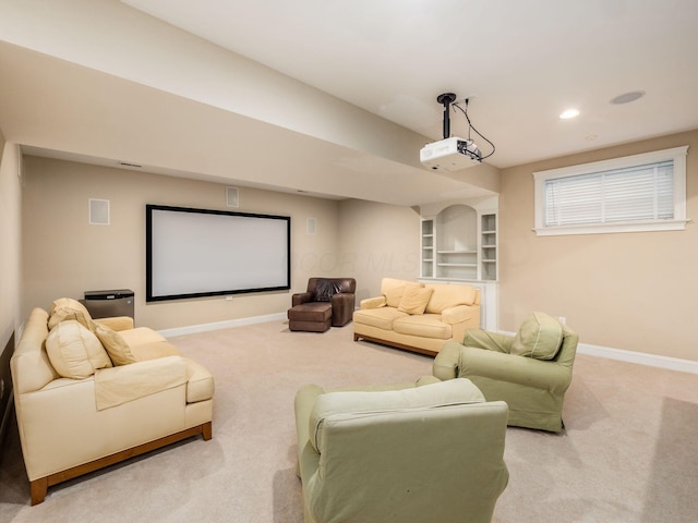 carpeted home theater featuring built in features