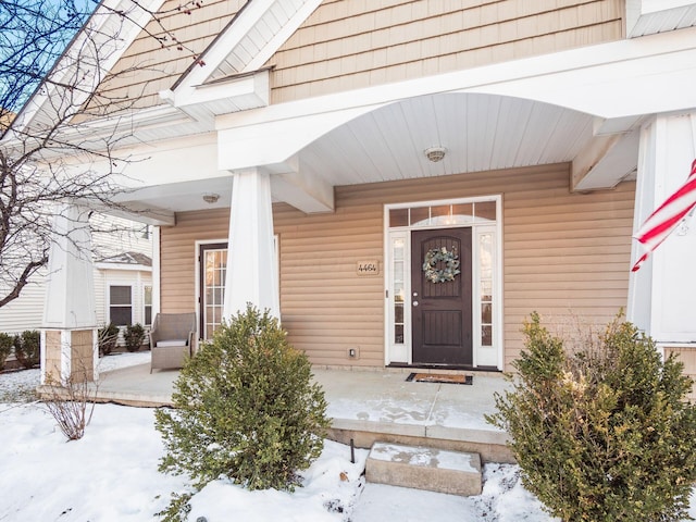 view of snow covered property entrance