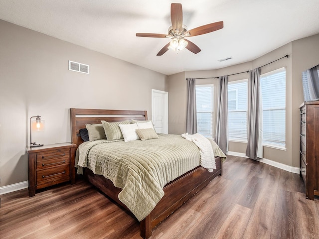 bedroom with dark wood-type flooring and ceiling fan