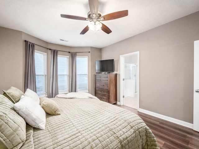 bedroom with ceiling fan, wood-type flooring, and ensuite bath