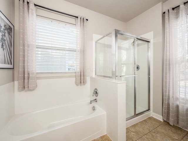 bathroom featuring tile patterned flooring and separate shower and tub