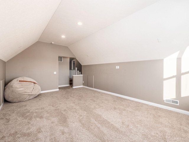 bonus room featuring carpet flooring and lofted ceiling