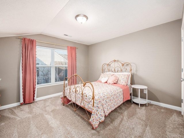 bedroom with carpet flooring and lofted ceiling