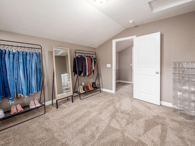 unfurnished bedroom featuring carpet, a textured ceiling, and vaulted ceiling