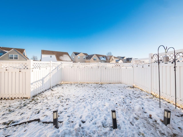 view of yard layered in snow