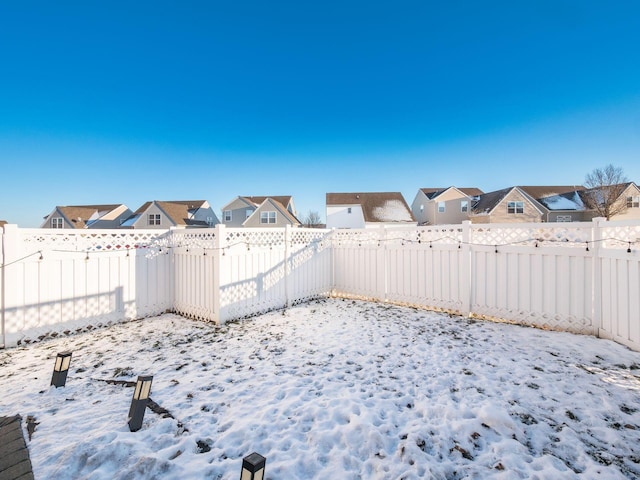 view of yard layered in snow