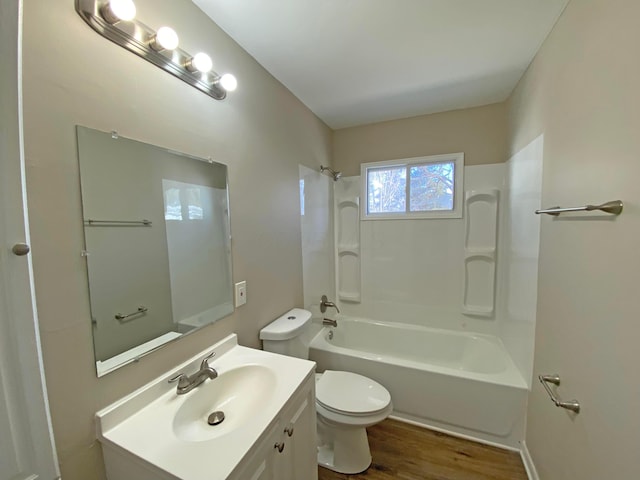 bathroom featuring washtub / shower combination, vanity, toilet, and wood finished floors