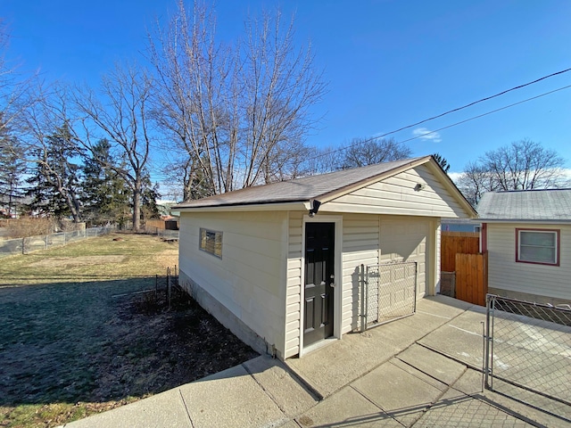detached garage featuring fence