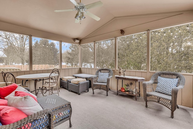 sunroom / solarium with ceiling fan and vaulted ceiling