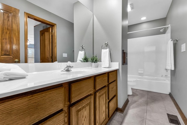 full bathroom with tub / shower combination, toilet, vanity, and tile patterned flooring