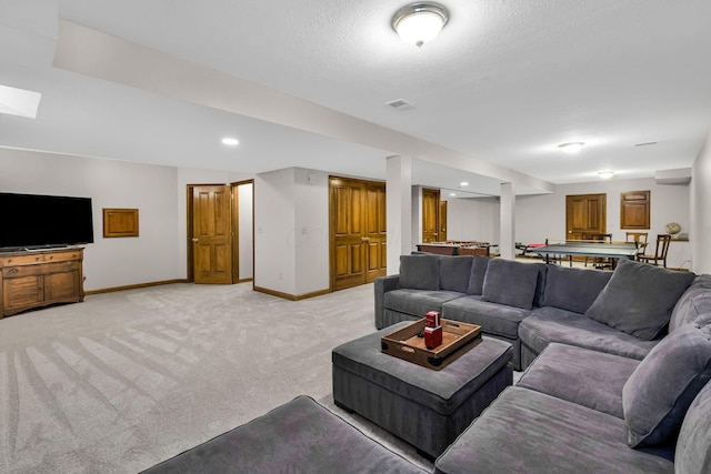 carpeted living room with a textured ceiling