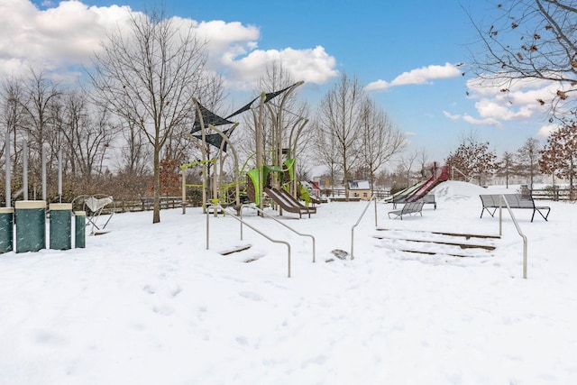 snowy yard featuring a playground