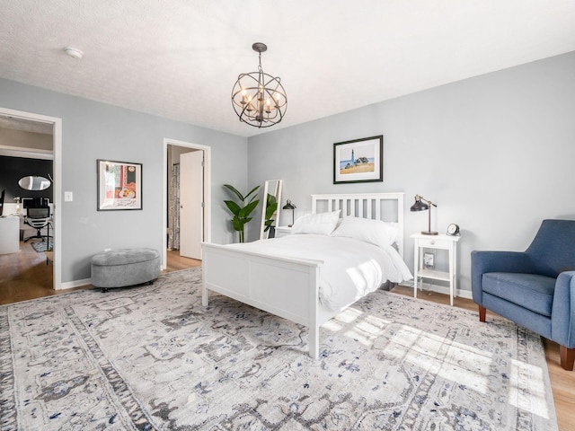 bedroom featuring light hardwood / wood-style floors and a chandelier