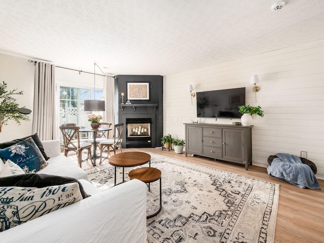 living room with light hardwood / wood-style flooring and a textured ceiling