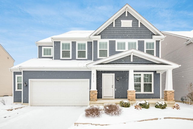 craftsman inspired home featuring a garage and a porch