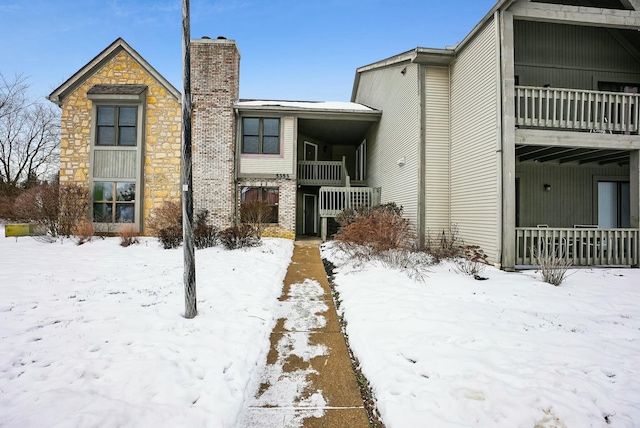 snow covered property featuring a balcony