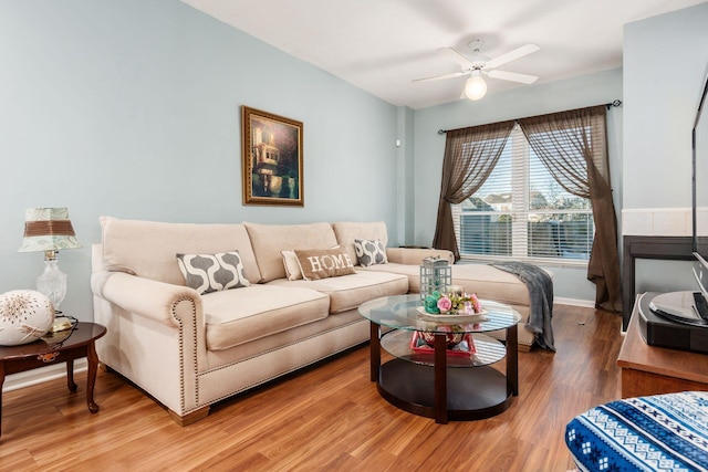 living room featuring ceiling fan and hardwood / wood-style floors