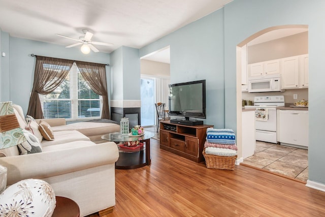 living room with ceiling fan and light hardwood / wood-style floors