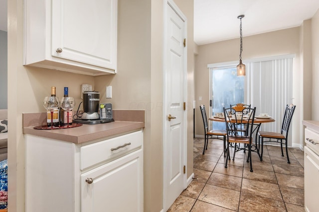 kitchen with hanging light fixtures and white cabinets