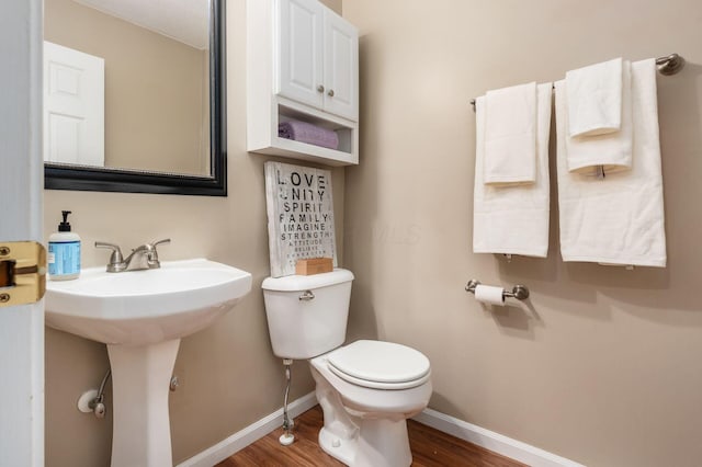 bathroom with toilet and wood-type flooring