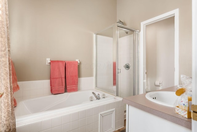 bathroom featuring vanity and shower with separate bathtub