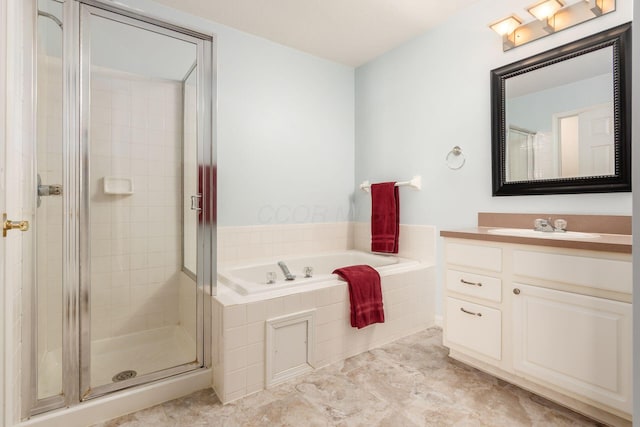 bathroom featuring vanity and independent shower and bath