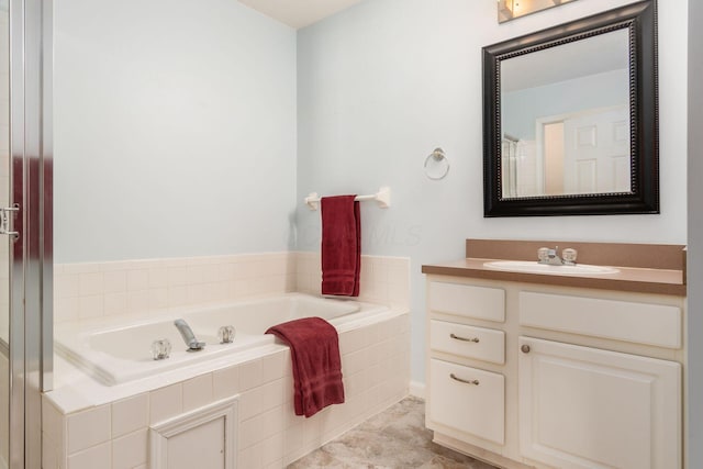 bathroom with vanity and a relaxing tiled tub