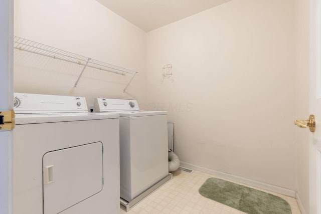 washroom with washer and dryer