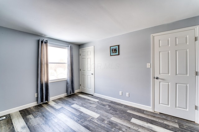 spare room with dark wood-type flooring