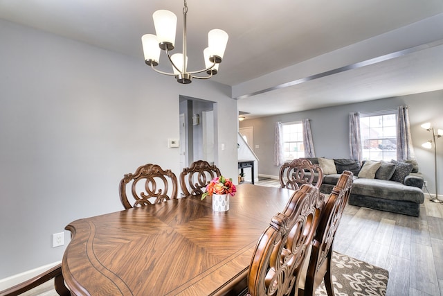 dining area featuring a notable chandelier and hardwood / wood-style floors