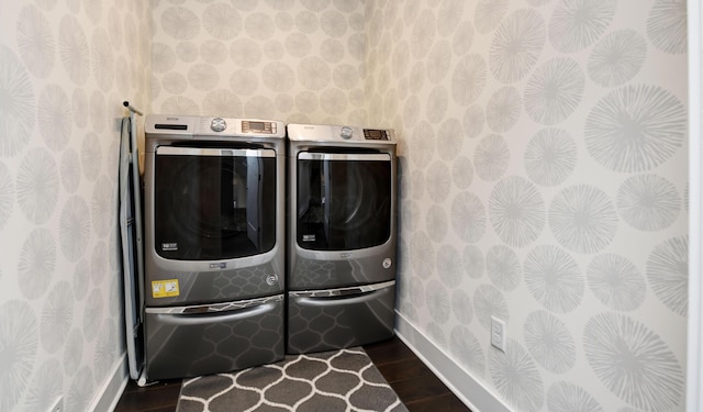 washroom featuring dark hardwood / wood-style flooring and washing machine and clothes dryer