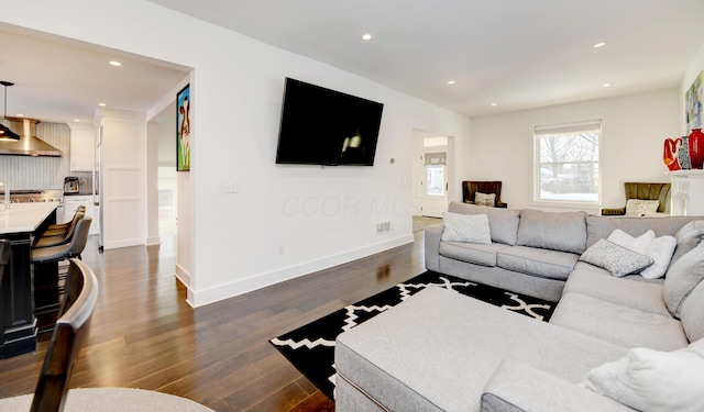 living room with dark hardwood / wood-style flooring