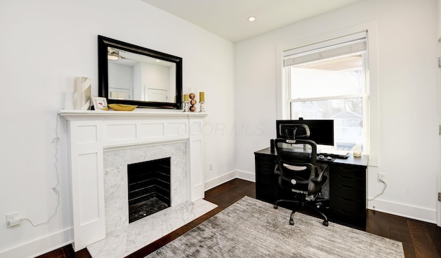 office area featuring a premium fireplace and dark hardwood / wood-style floors