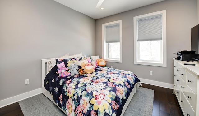 bedroom with ceiling fan and dark hardwood / wood-style flooring