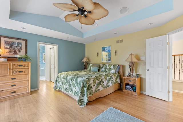 bedroom with lofted ceiling, baseboards, visible vents, and light wood-style floors