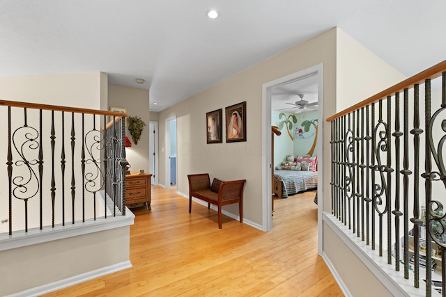 foyer entrance with light wood-style flooring, stairway, baseboards, and recessed lighting