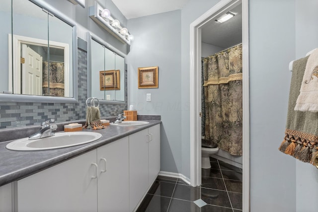 bathroom with tile patterned flooring, a sink, and decorative backsplash