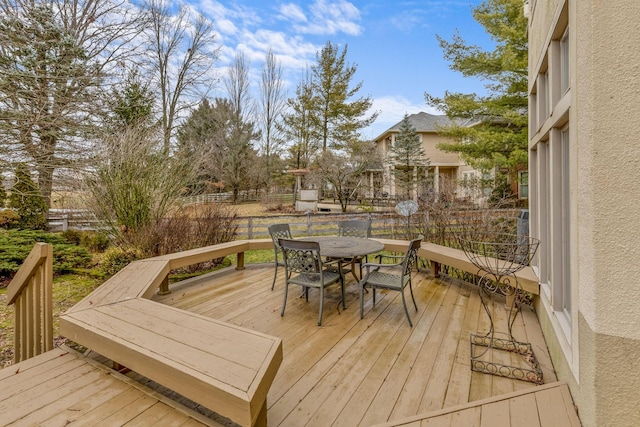 deck featuring outdoor dining space and fence