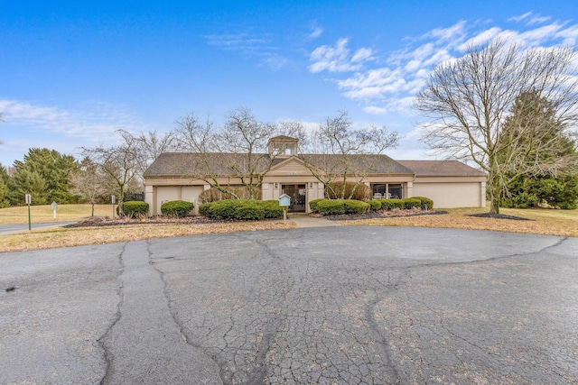 ranch-style house featuring driveway and an attached garage