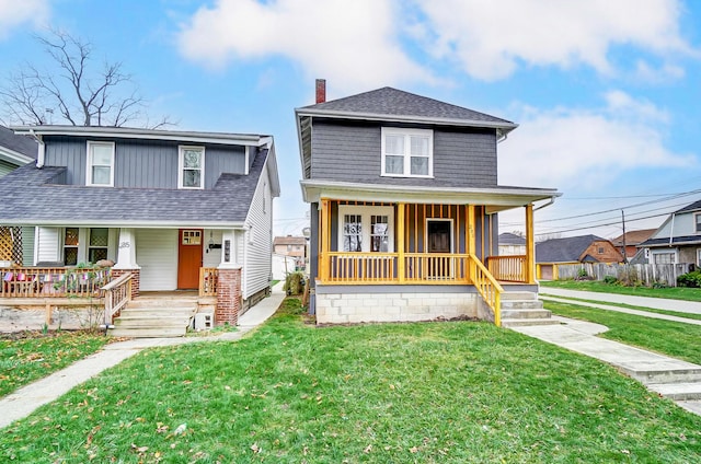 view of front of property with a front yard and covered porch