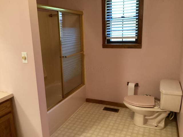 full bathroom with toilet, combined bath / shower with glass door, and vanity