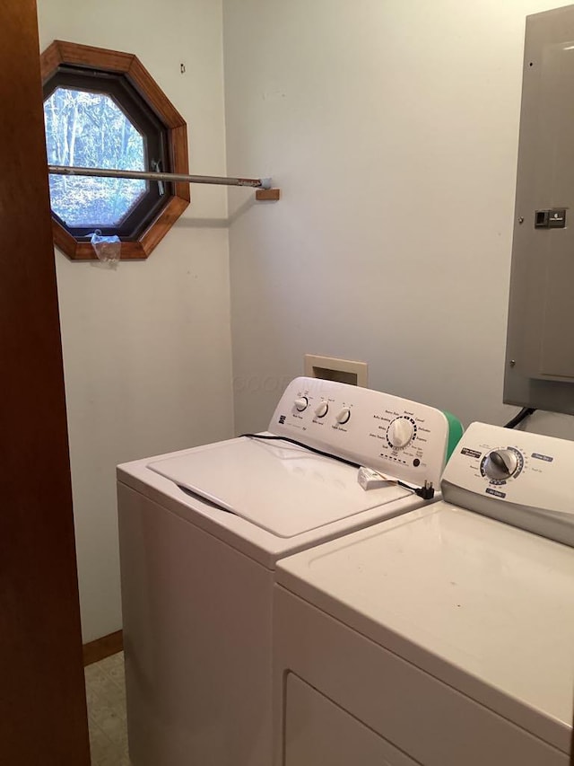 clothes washing area featuring washer and clothes dryer and electric panel