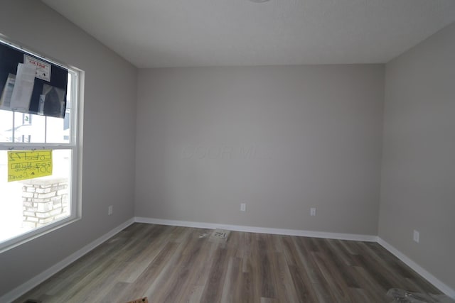 unfurnished room featuring dark hardwood / wood-style flooring