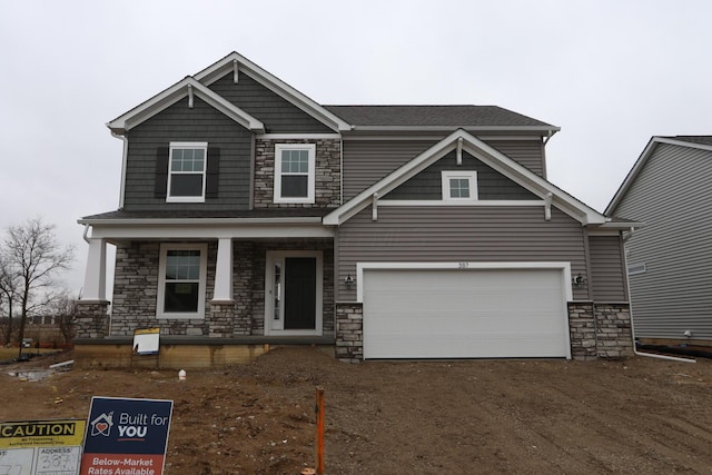 craftsman inspired home with a garage and covered porch